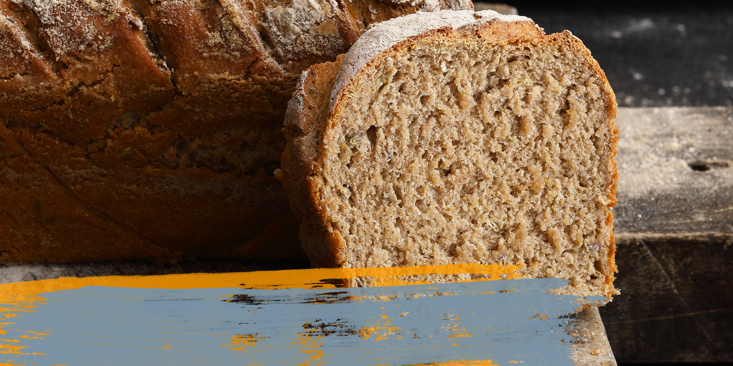 Close-up of sliced bread with a rustic background, showing the texture and details.