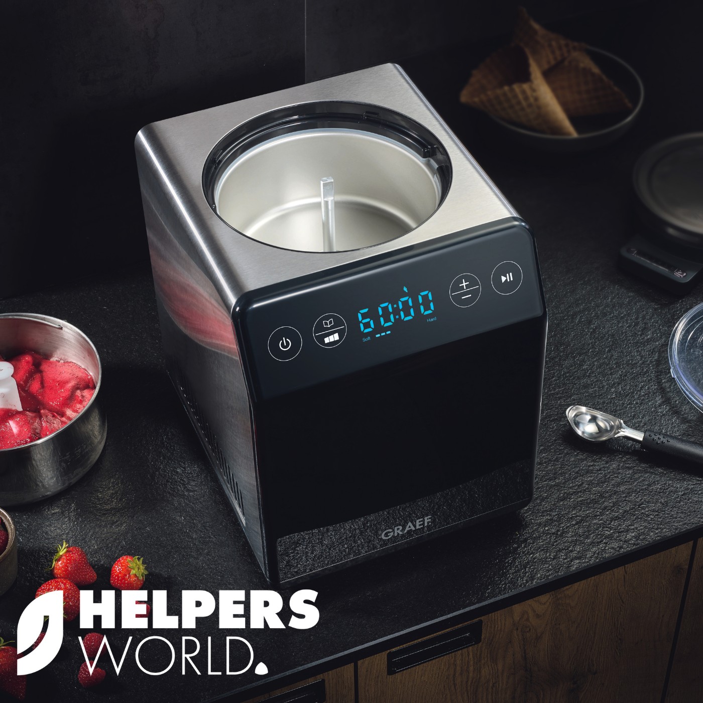 Ice cream maker with strawberries and waffles on black table, GRAEF.
