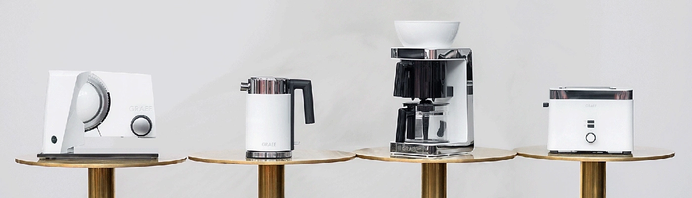 Graef kitchen appliances on golden tables against a light background.