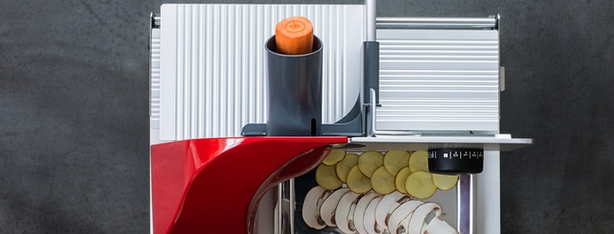 Vegetable slicer with carrot, potatoes and mushrooms, red and silver