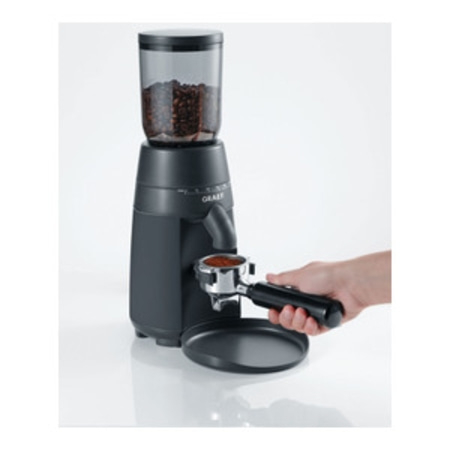 Moulin à café avec grains et porte-filtre, prêt pour l'espresso.