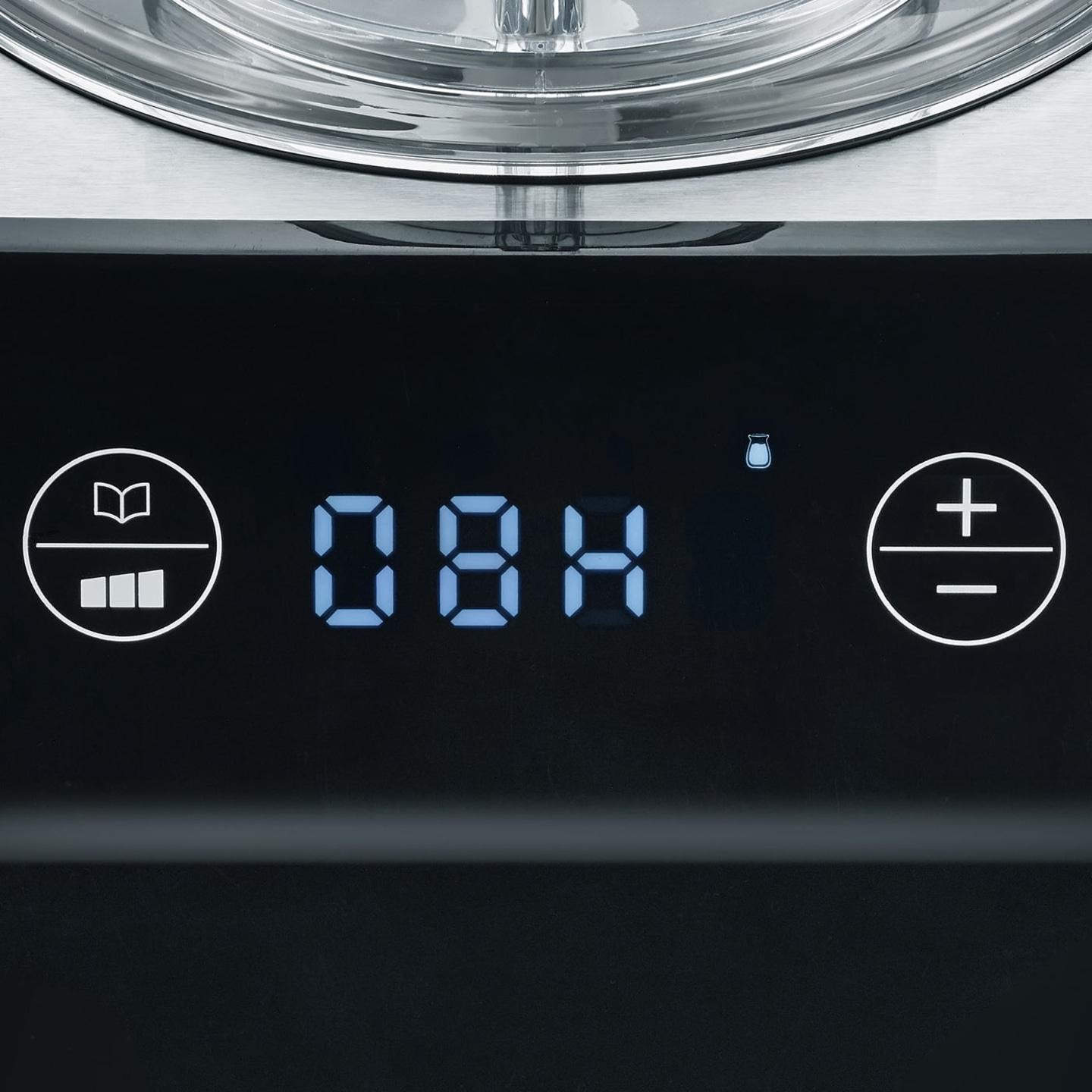 Close-up of a black control panel with digital display and various symbols.
