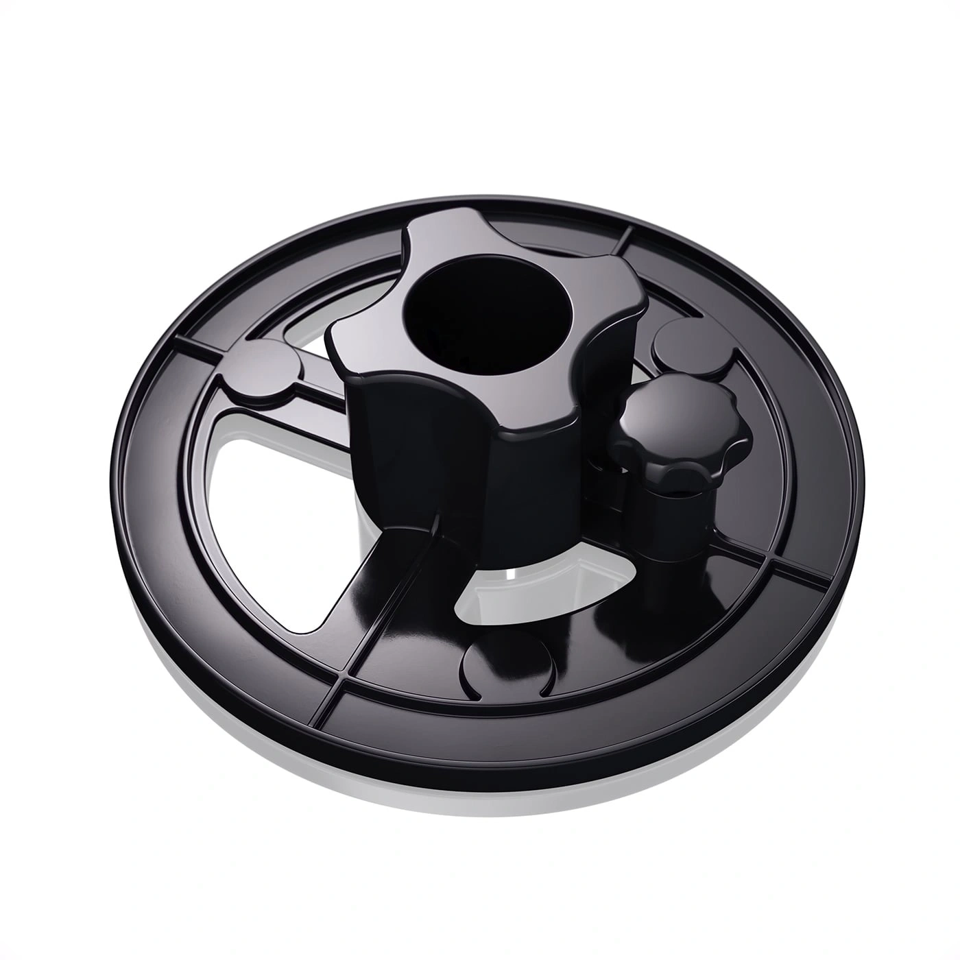 Black plastic base with knobs and holes for a machine or device, isolated.