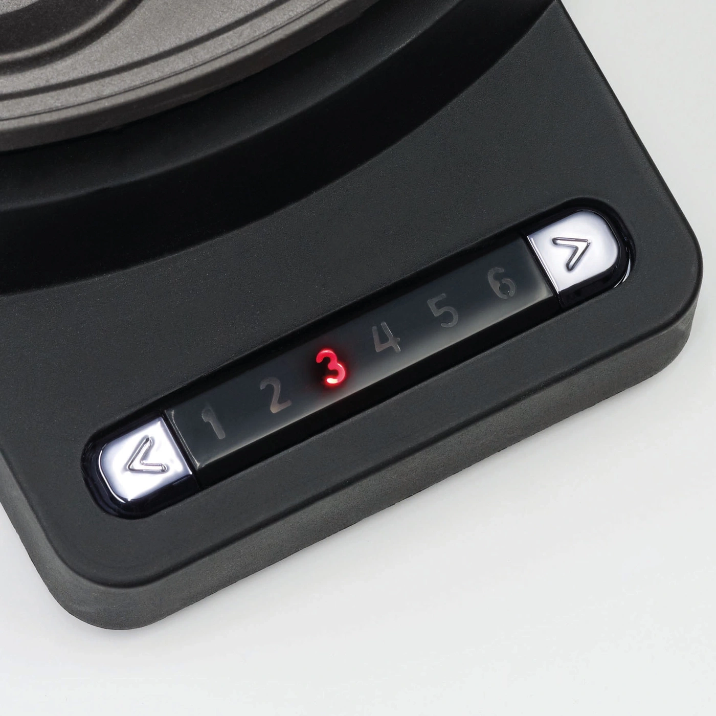 Black device with illuminated numbers 1-6 and arrow buttons for settings adjustment.