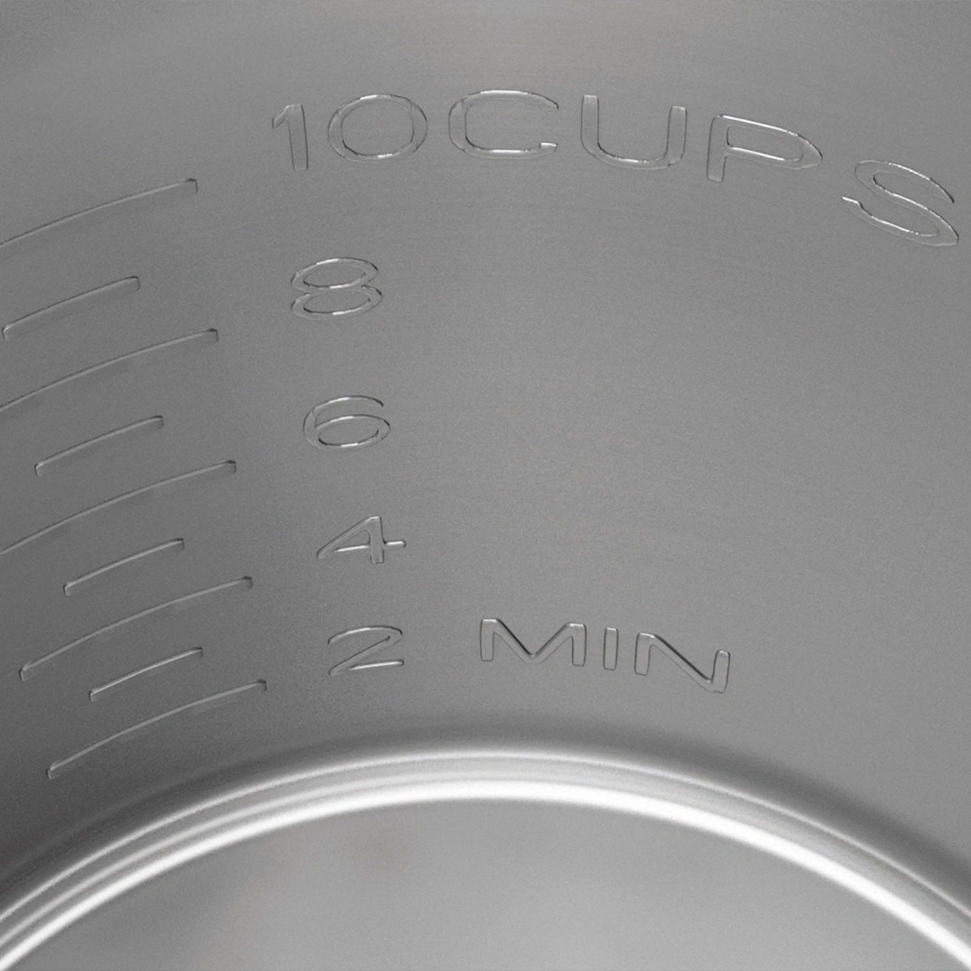 Measuring markings for cups and minutes on a metal container.