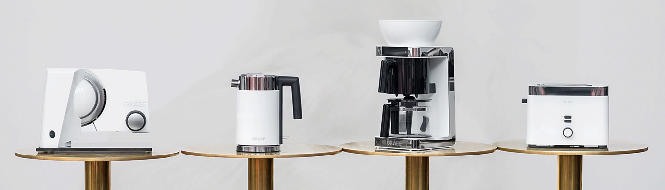 Graef kitchen appliances on golden tables against a light background.