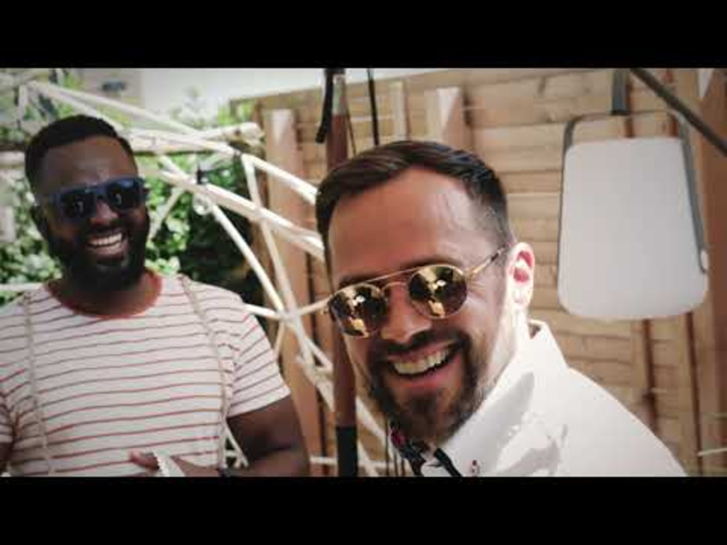 Two men smiling, sunglasses, outdoors, summer, joy, happy, friends, laughing, positive.