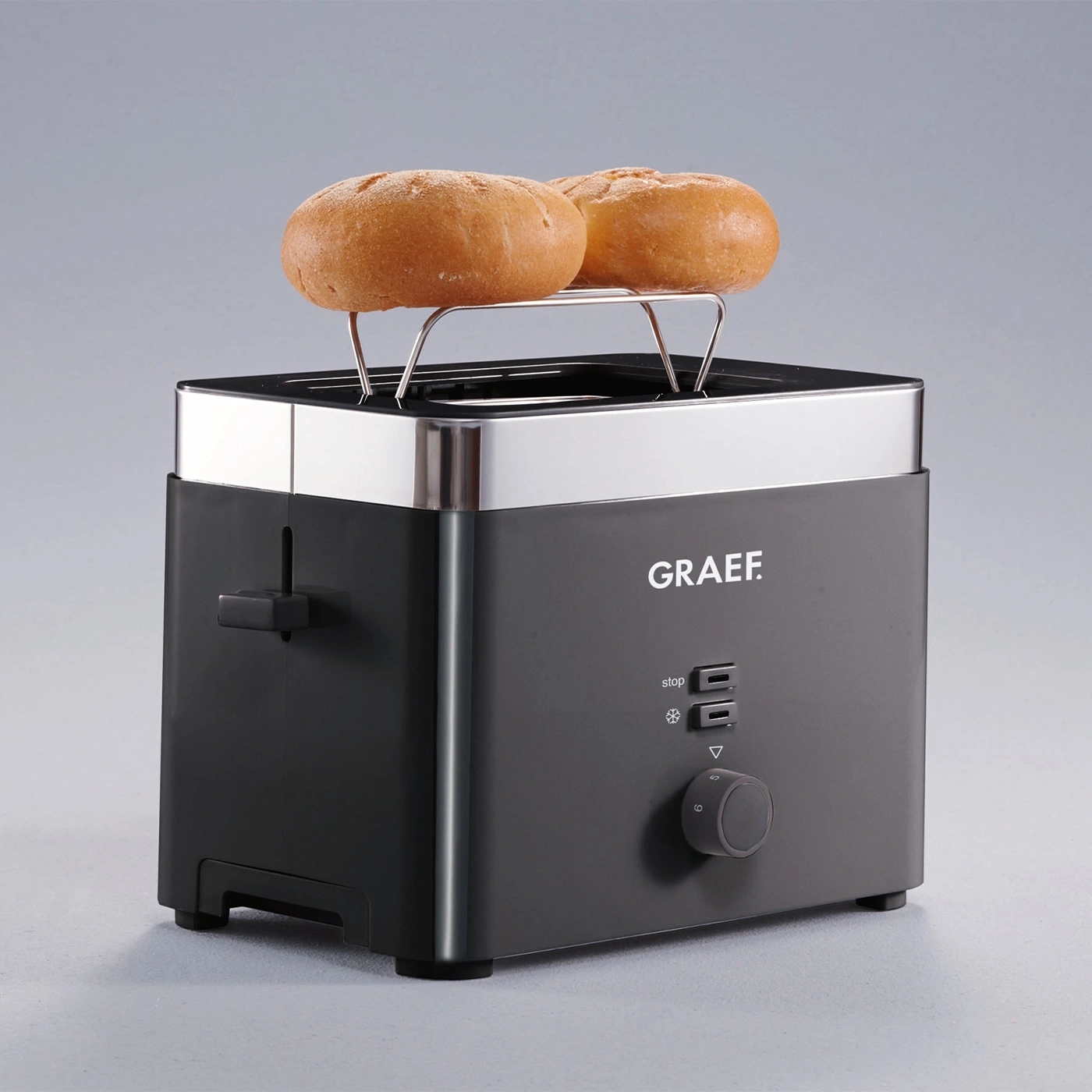 Graef toaster with bun attachment and two buns on a gray background