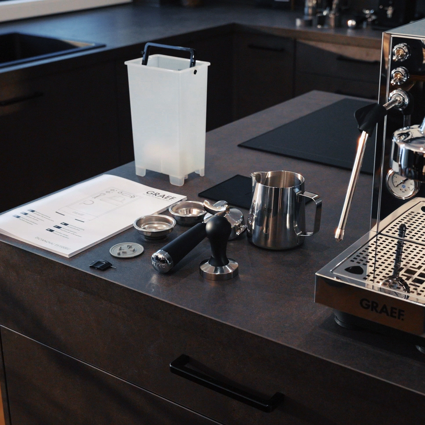 Espresso machine with accessories on a countertop