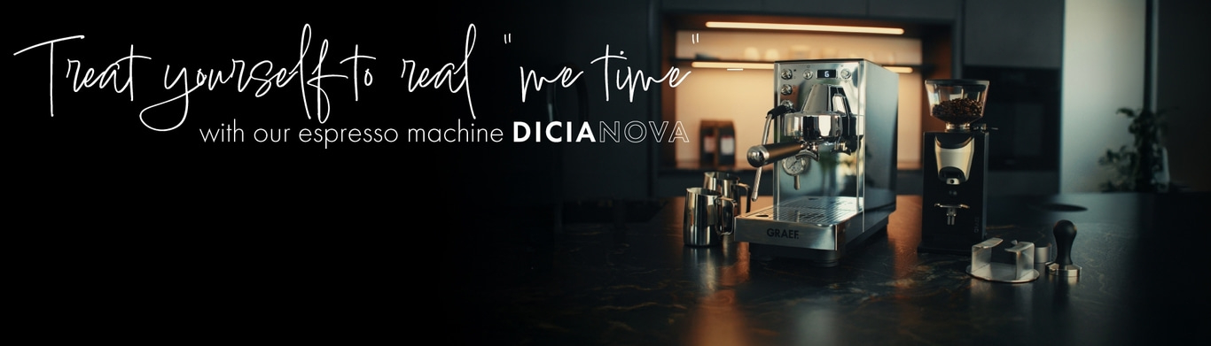 Espresso machine with coffee grinder and tamper on a dark worktop