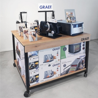 GRAEF-Produkte auf einem Tisch mit Rädern, Küchengeräte und Zubehör.