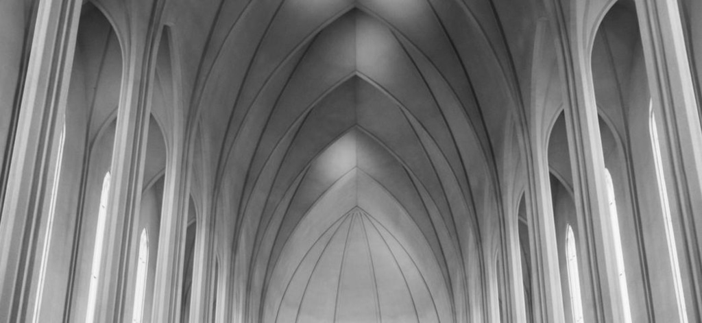 Graustufen-Innenansicht einer Kirche mit gewölbter Decke und Säulen