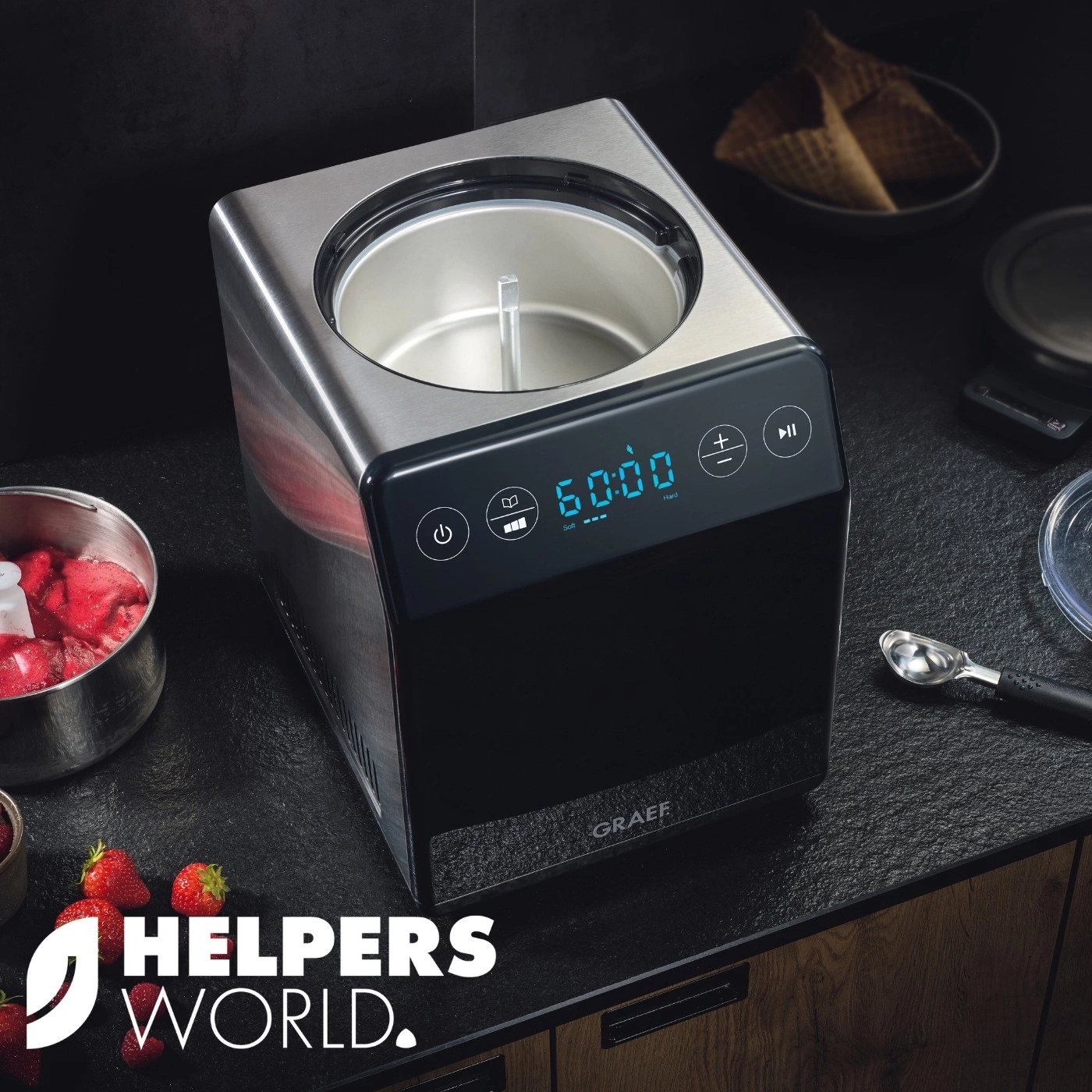 Ice cream maker with strawberries and waffles on black table, GRAEF.