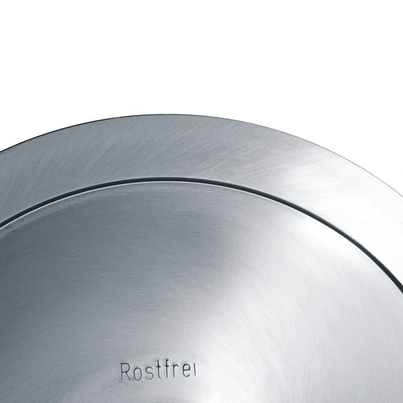 Nahaufnahme von rostfreiem Metall mit der Aufschrift 'Rostfrei' in der Mitte.