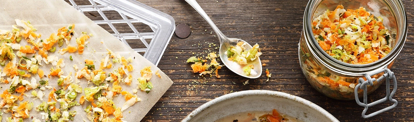 Close-up of vegetables on a wooden table with a jar and a spoon