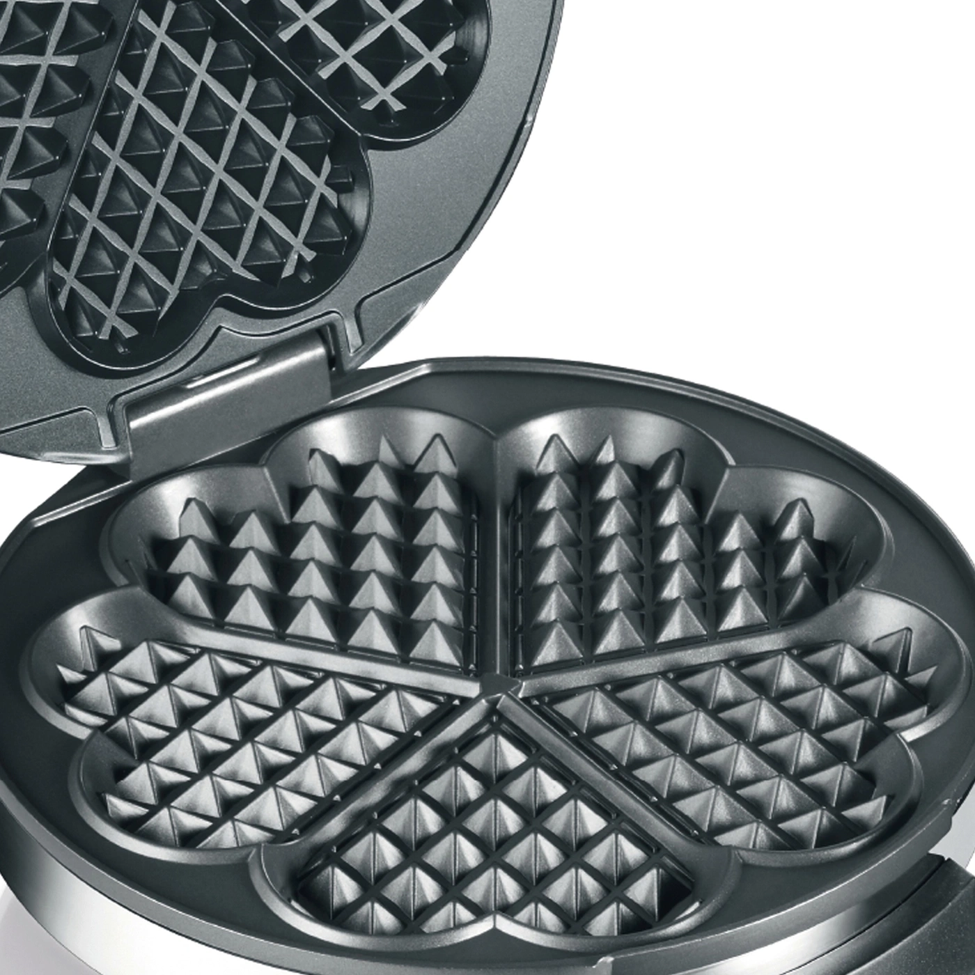 Waffle iron, open, with heart-shaped indentations, close-up, gray