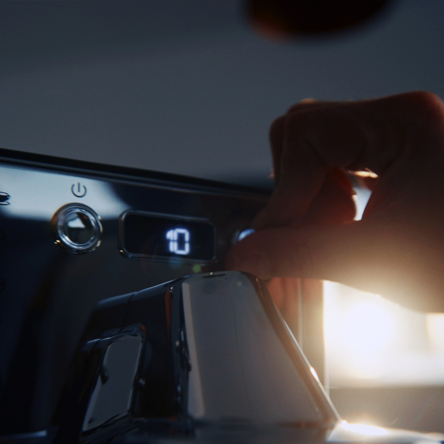 Hand stellt eine Zahl auf einem digitalen Display ein.