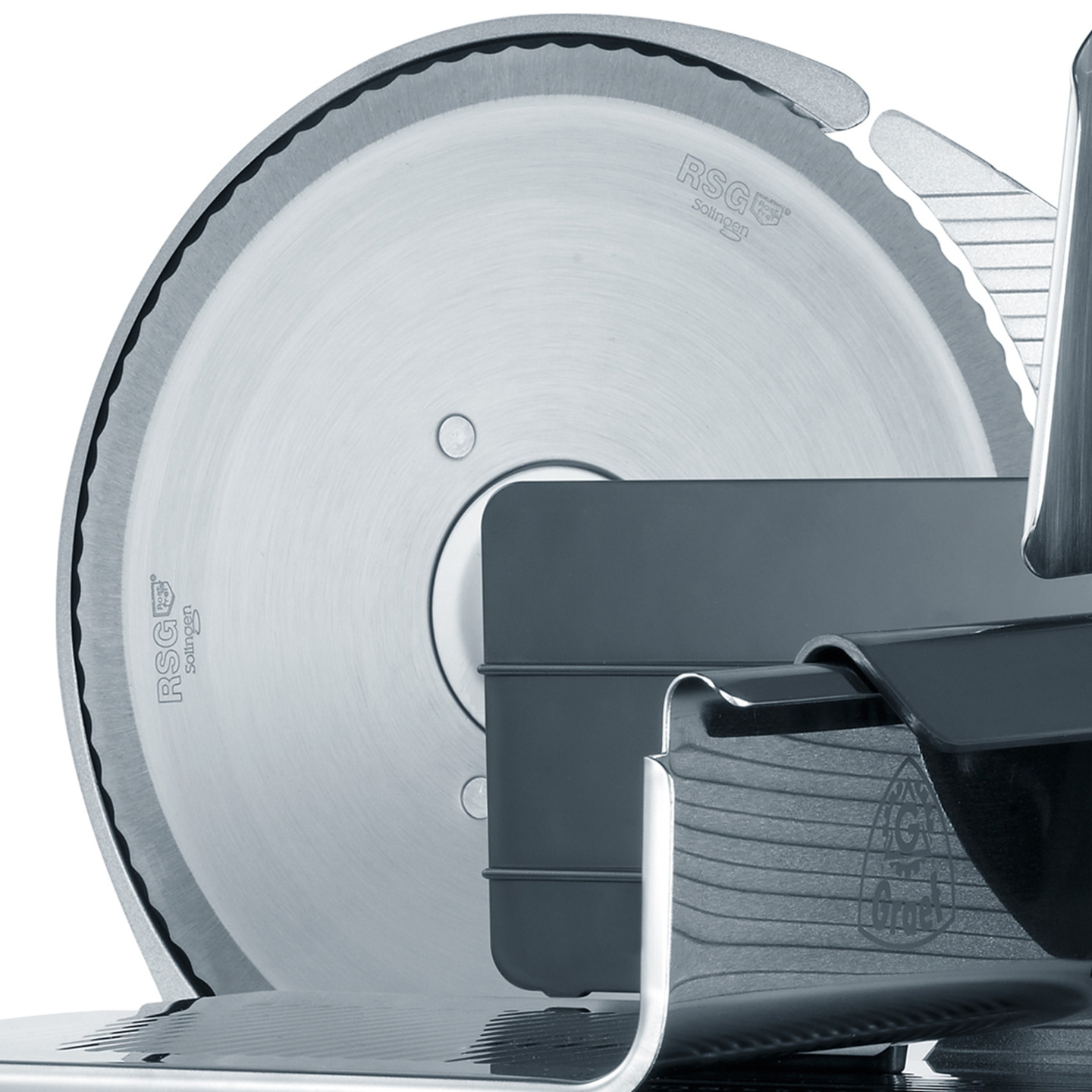 Close-up of a meat slicer with a sharp blade and intricate details.