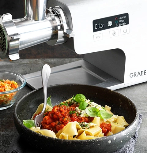 Meat grinder with pasta and tomato sauce, basil, food, kitchen