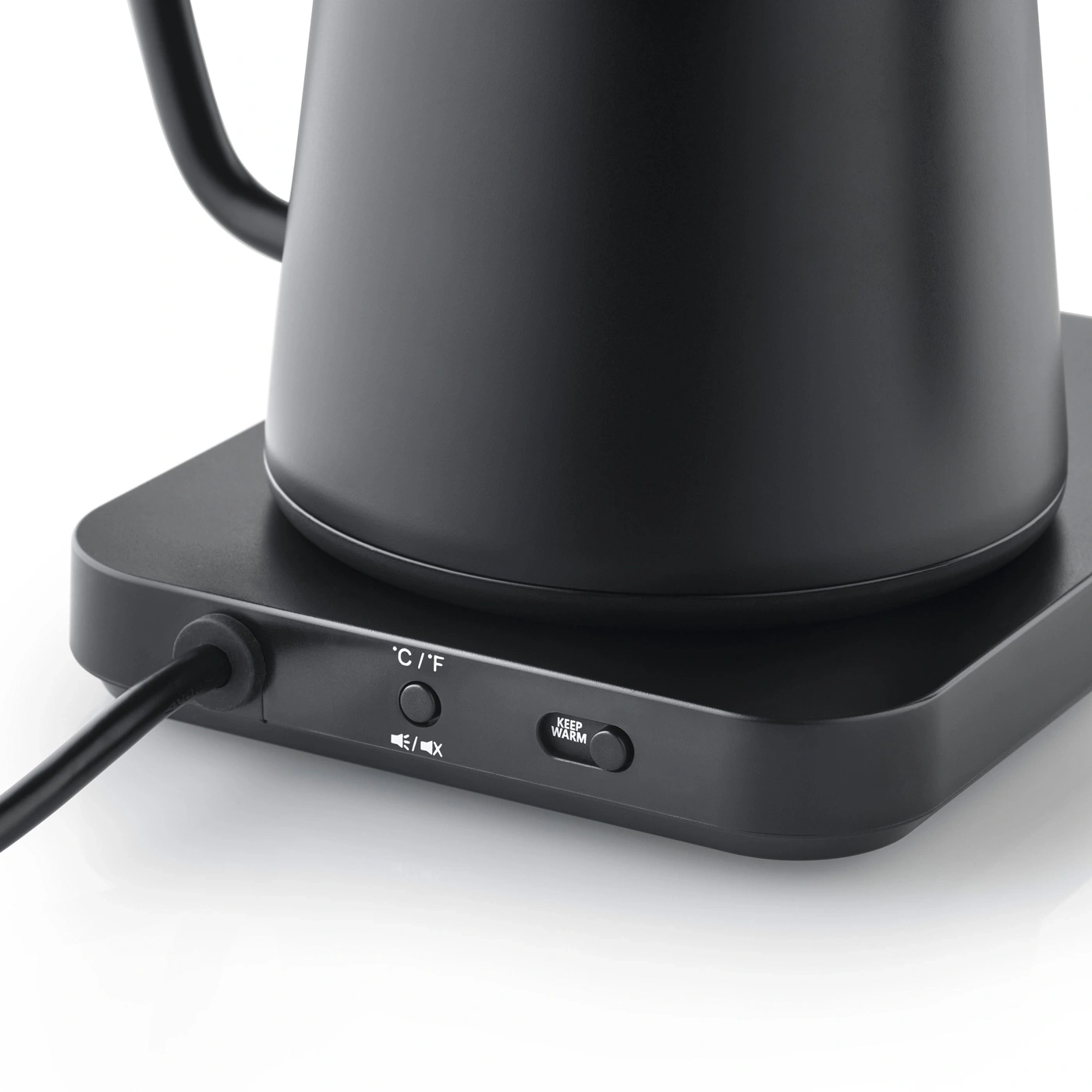 Black electric kettle with controls and power cord on a white surface.