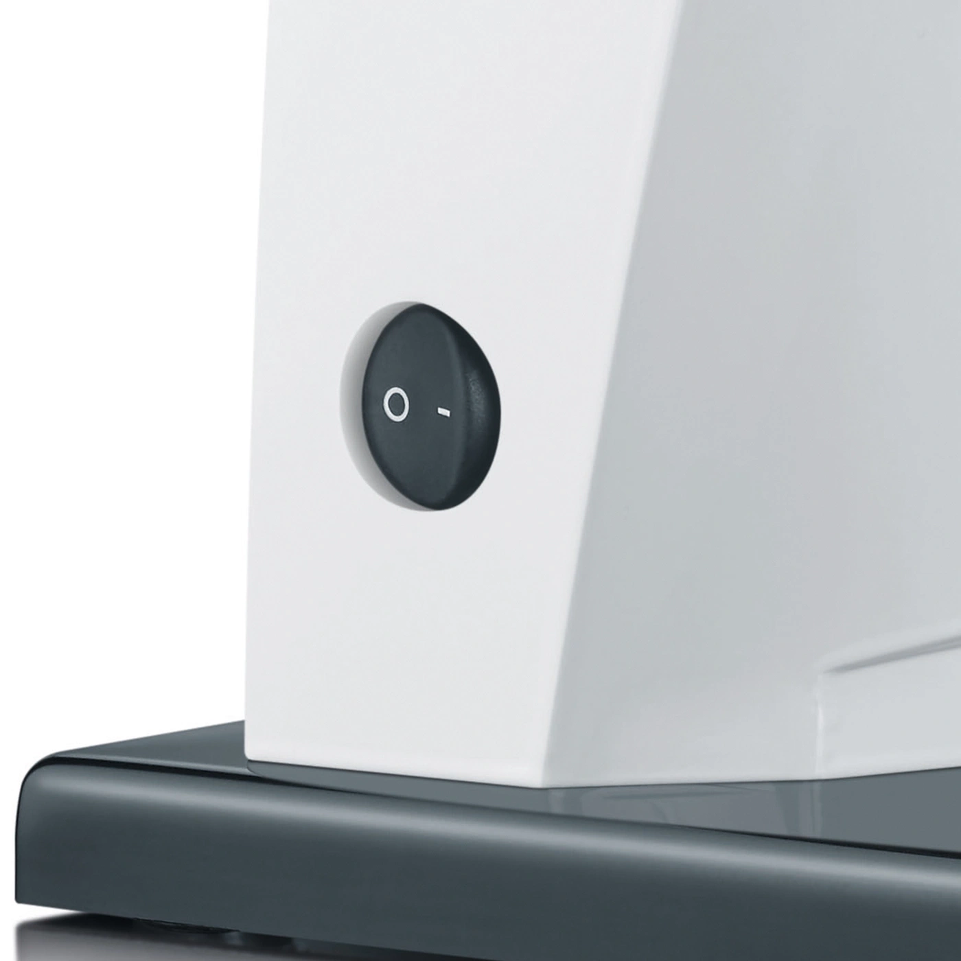 On/Off switch on a white device on a gray surface, close-up shot.